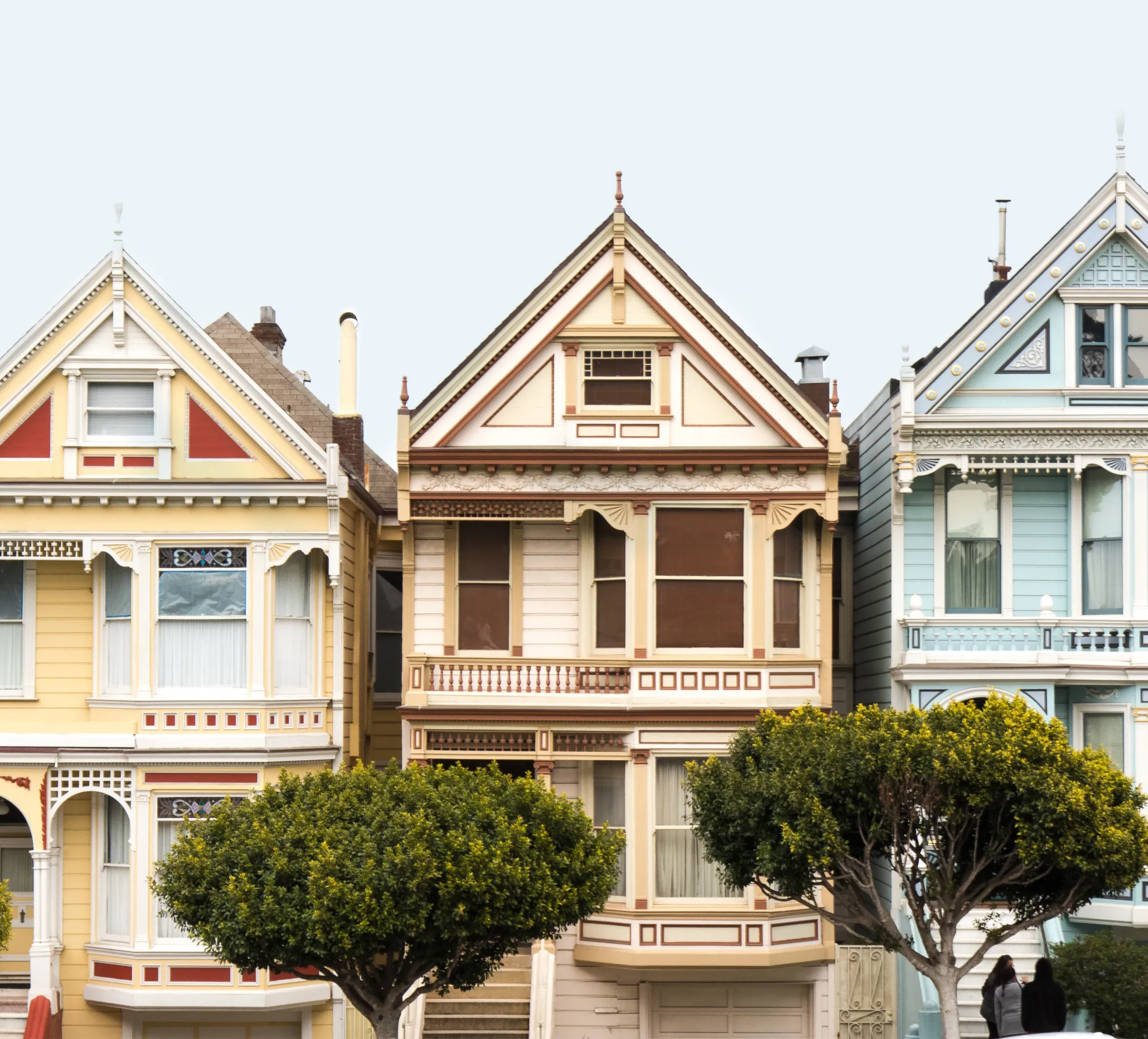 Colourful houses against a pale blue sky.