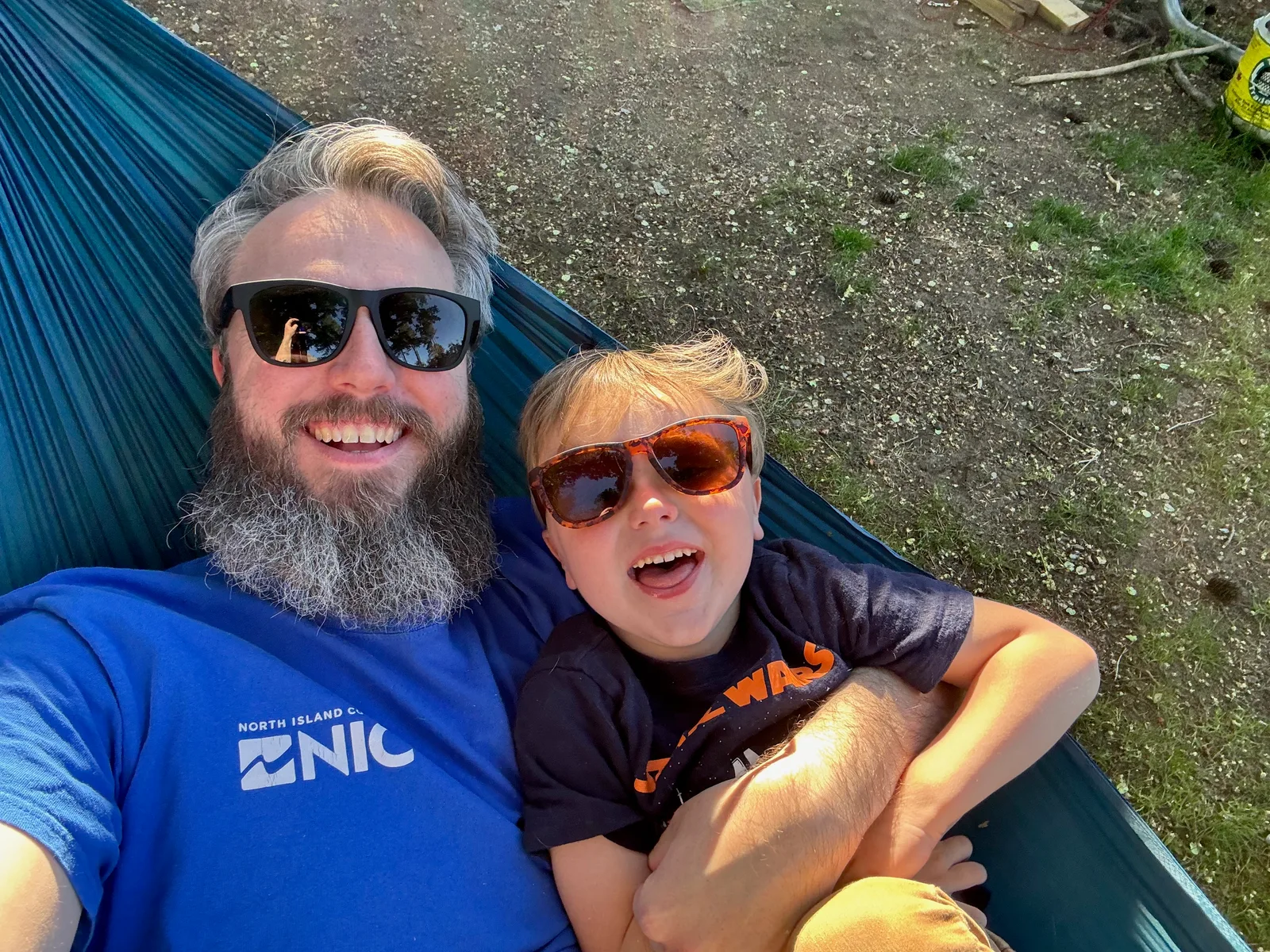 Craig and his son in a hammock.