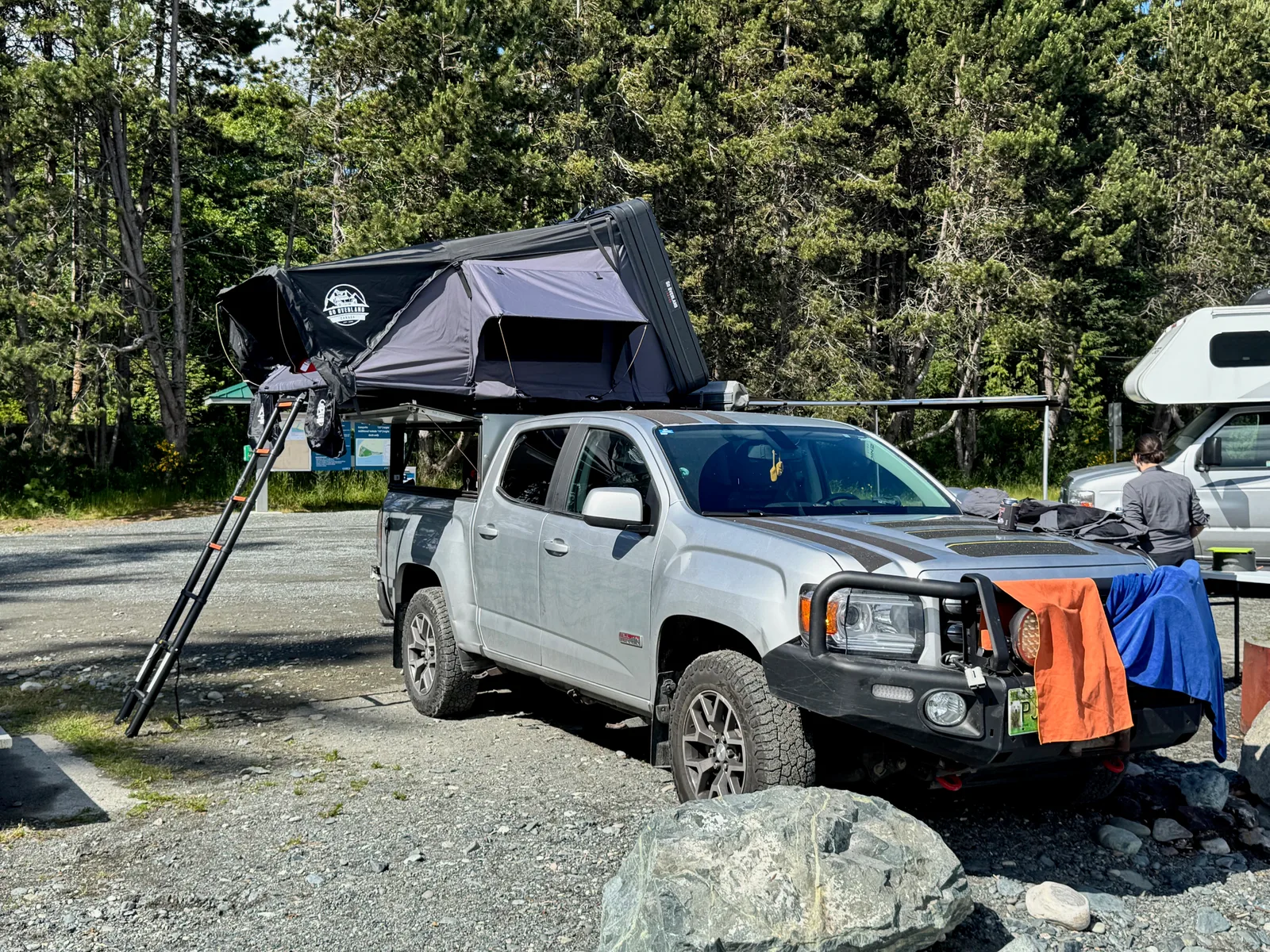 An overland truck with some towels drying on the bull bar