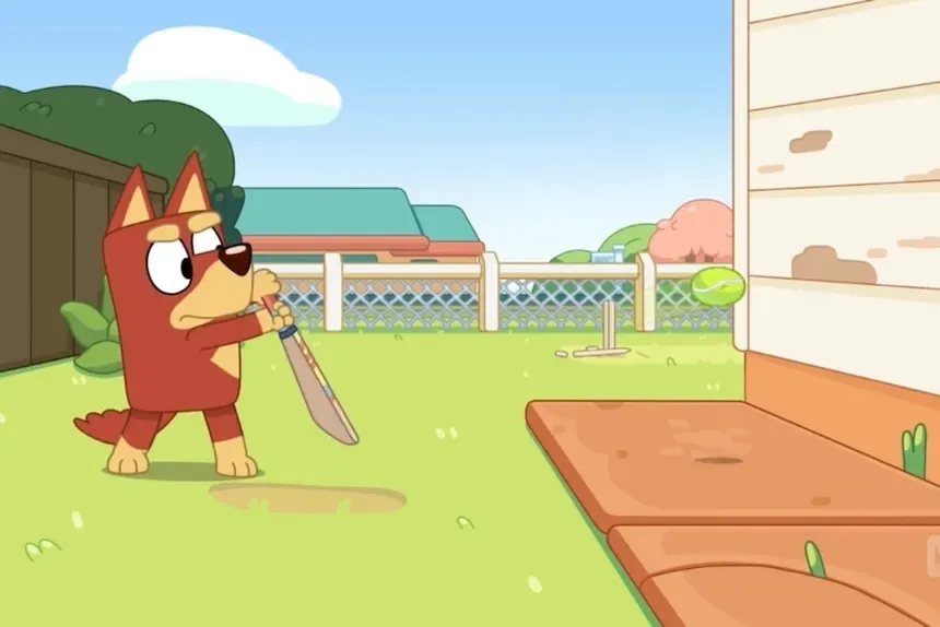 Bandit from Bluey swinging a cricket bat in the back garden as the ball flies past him.