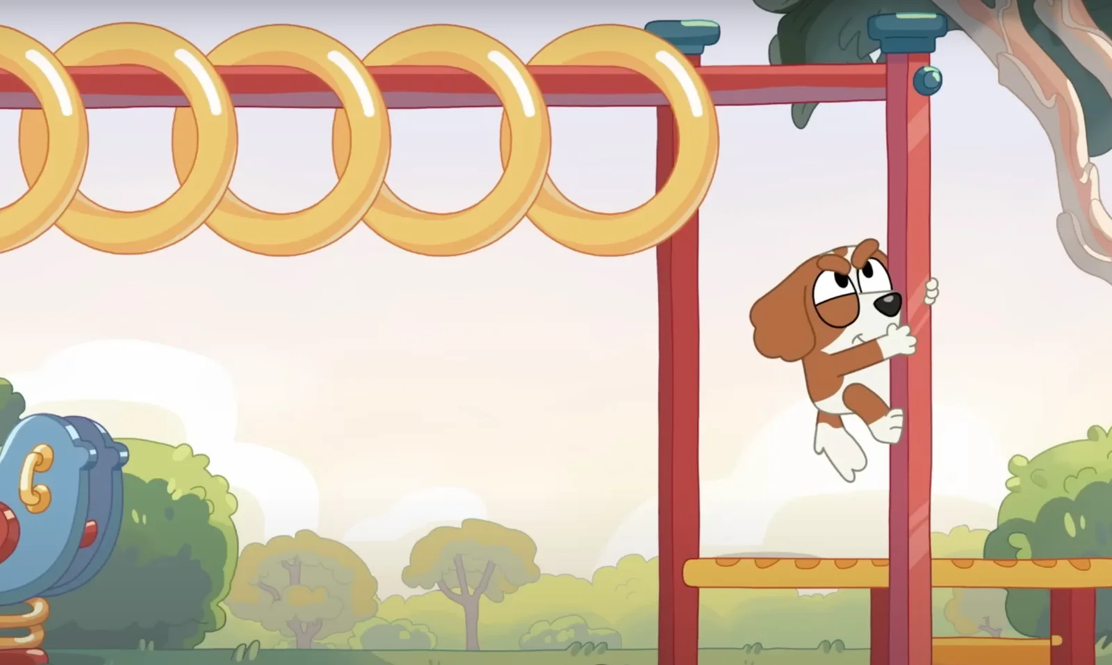 Bentley is climbing the support pole of the monkey bars in order to reach them.