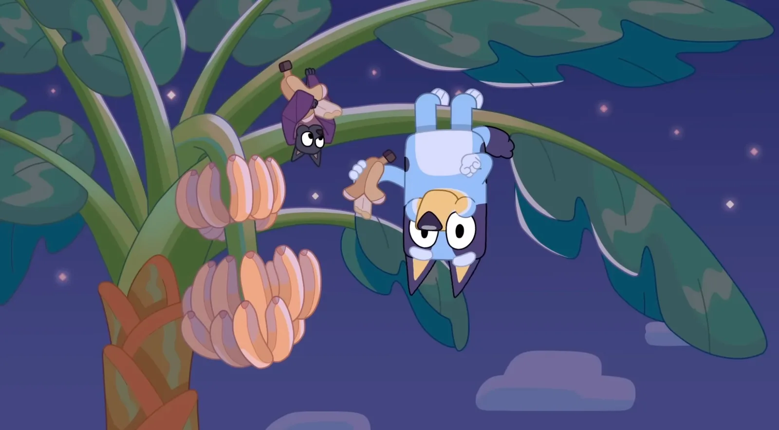 Bluey hanging upside down in a tree eating fruit